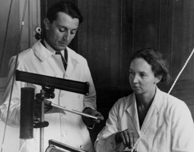 old photograph of two people in a lab