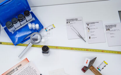 Overhead view of DNA evidence kit on white background.