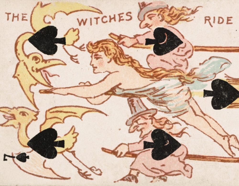 Back of a 7 of spades card featuring witches riding broomsticks with golden birds