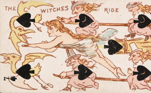 Back of a 7 of spades card featuring witches riding broomsticks with golden birds